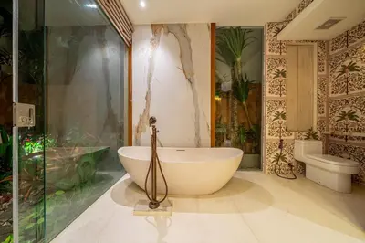 a bathroom with a bath tub and a shower at Sweet Surrender - Stylish 4BR Near Potato Head in Seminyak