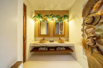 a bathroom with two sinks and a mirror at Sweet Surrender - Stylish 4BR Near Potato Head in Seminyak