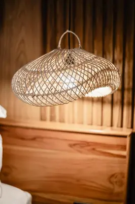 a light fixture hanging over a bed in a room at Dharman Royal Villas in Kerobokan