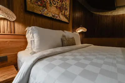 a bedroom with a large bed with white pillows at Dharman Royal Villas in Kerobokan