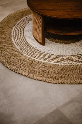 a large rug with a wooden table on a floor at Dharman Royal Villas in Kerobokan