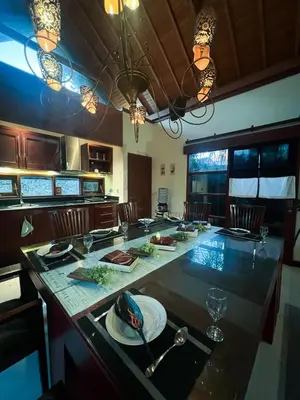 a kitchen with a large counter top with plates and glasses at Ohara Hideway 3BR Japanese Vibes Villa in Kerobokan Seminyak Bali in Seminyak