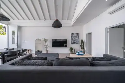 a living room with a couch and a table at Sandy Shores Villa 3 Modern 3BR Villa in Canggu in Canggu