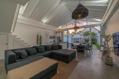 a living room with a couch and a table at Sandy Shores Villa 3 Modern 3BR Villa in Canggu in Canggu