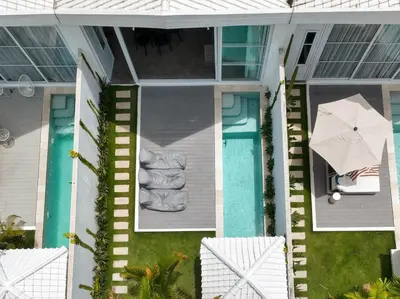 an overhead view of a house with a pool and an umbrella at Sandy Shores Villa 3 Modern 3BR Villa in Canggu in Canggu