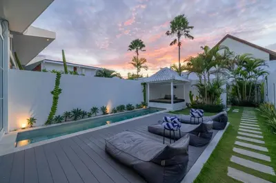 a patio with couches and a pool in a house at Sandy Shores Villa 3 Modern 3BR Villa in Canggu in Canggu