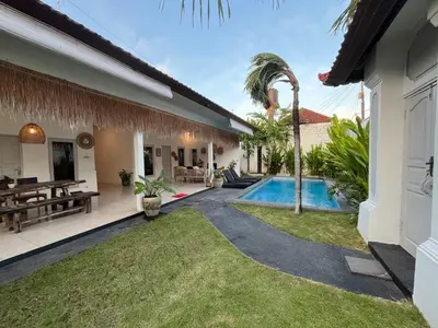 a backyard of a house with a swimming pool at Kondo Villa 2 BR- Private Pool in Seminyak