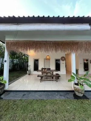 a patio of a house with a picnic table at Kondo Villa 2 BR- Private Pool in Seminyak