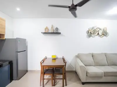 a living room with a couch and a table at Town House, Modern Minimalis, Lokasi Strategis in Seminyak