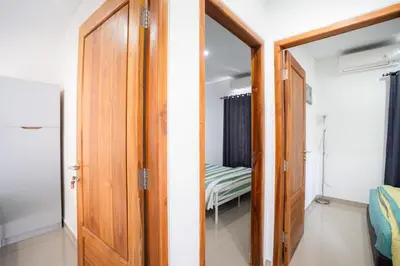 a door leading to a bedroom with a bed at Town House, Modern Minimalis, Lokasi Strategis in Seminyak