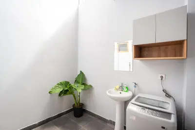 a small bathroom with a sink and a toilet at Town House, Modern Minimalis, Lokasi Strategis in Seminyak