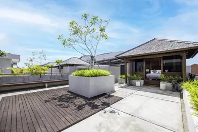 a bedroom on the roof of a house at Astamaya Signature Villas in Seminyak
