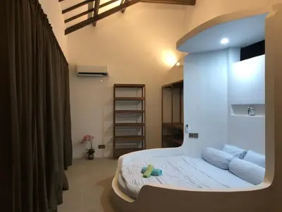 a bedroom with a bed in a room at Villa Denira, Home Gym & Private Pool in Nusa Dua