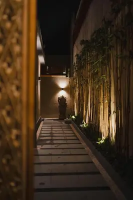 a walkway with plants on the side of a building at Dikubu Belong VILLA in Denpasar