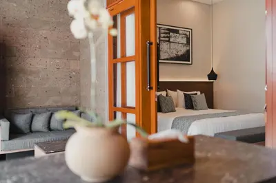 a hotel room with a bed and a couch at Dikubu Belong VILLA in Denpasar