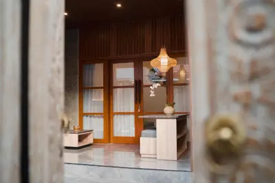 a room with a door and a vase on a table at Dikubu Belong VILLA in Denpasar