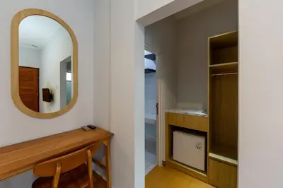 a bathroom with a mirror and a closet at Cove De Pavilla in Sanur