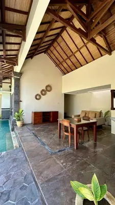 a living room with a table and a couch at Seminyak Classic 1BRoom Private Pool Villa in Seminyak