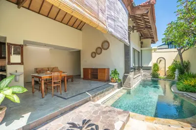 a house with a pool and a table and a dining room at Seminyak Classic 1BRoom Private Pool Villa in Seminyak