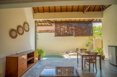 a living room with a table and chairs and a pool at Seminyak Classic 1BRoom Private Pool Villa in Seminyak