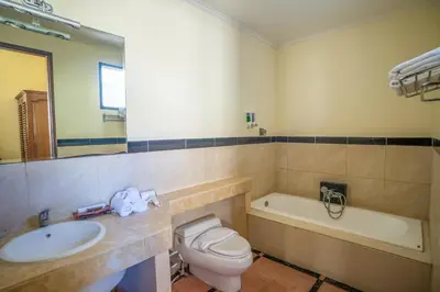 a bathroom with a sink and a toilet and a tub at Villa PBC 2 Bed Room Private Pool in Seminyak in Seminyak