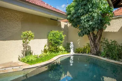 a small swimming pool in front of a house at Clasic 3BRoom Villa In Seminyak in Seminyak