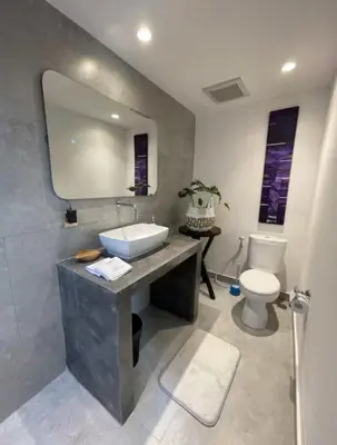 a bathroom with a sink and a toilet at Three Bedrooms Elegant Home The White Door Villa in Sanur