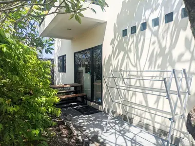 a white house with a staircase leading to the front door at The Lavana Villa Singgahan Jimbaran - 3 Bedroom Villa in Nusa Dua