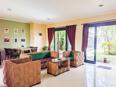 a living room with a couch and a table at The Lavana Villa Singgahan Jimbaran - 3 Bedroom Villa in Nusa Dua