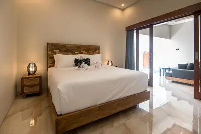 a bedroom with a bed with two stuffed animals on it at Villa Sakura ll seminyak in Seminyak