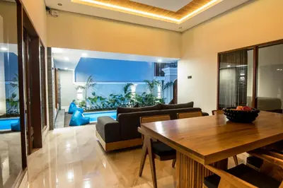 a living room with a table and a large aquarium at Villa Sakura ll seminyak in Seminyak