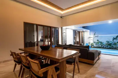 a dining room with a table and a couch at Villa Sakura ll seminyak in Seminyak