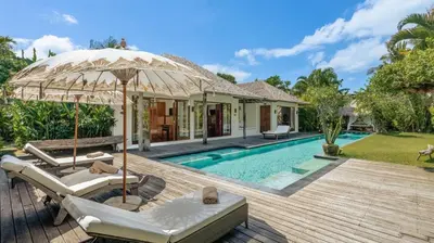 a villa with a swimming pool and a wooden deck at Villa Bidadari With Pool in Seminyak