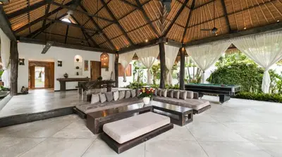 an outdoor living room with couches and a pool table at Villa Bidadari With Pool in Seminyak