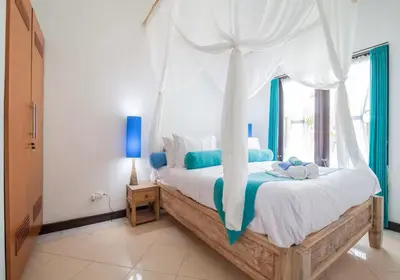 a bedroom with a large bed with a canopy at Villa Marjens 2 Seminyak area Bali in Kerobokan