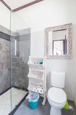 a bathroom with a toilet and a glass shower at Villa Marjens 2 Seminyak area Bali in Kerobokan