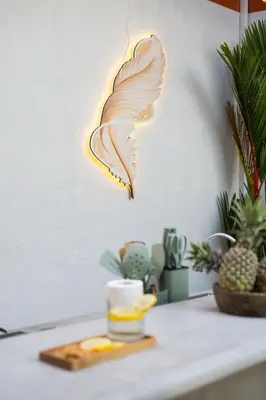 a light up butterfly lamp hanging on a wall at NaraDama Villa Seminyak Bali in Seminyak