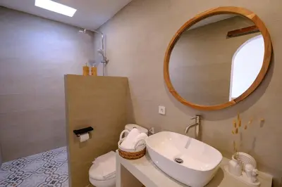 a bathroom with a sink and a mirror at New Vindra I Villa 2BR in the heart of Berawa in Canggu