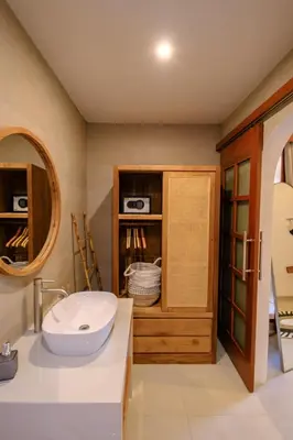 a bathroom with a sink and a mirror at New Vindra I Villa 2BR in the heart of Berawa in Canggu