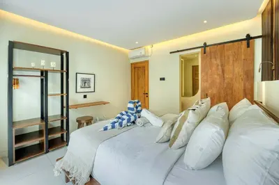 a bedroom with two beds with white pillows at Casa De Fiero A4 2BR Villa In Seminyak in Seminyak