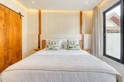 a bedroom with a large bed with a window at Casa De Fiero A4 2BR Villa In Seminyak in Seminyak