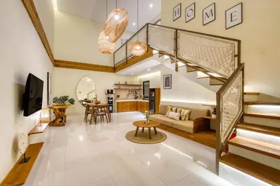 a living room with a staircase and a living room at Casa De Fiero A4 2BR Villa In Seminyak in Seminyak