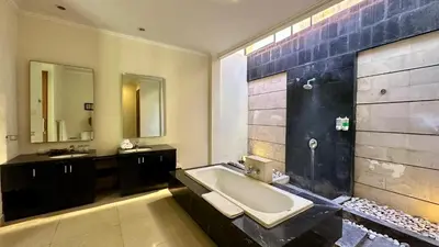 a bathroom with a tub and a sink and a mirror at 1 Bed Room Private Pool Villa in Seminyak - PBM1 in Seminyak