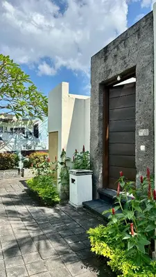 a house with a garage door and some flowers at 1 Bed Room Private Pool Villa in Seminyak - PBM1 in Seminyak