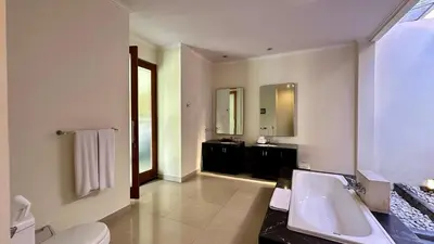 a large bathroom with a sink and a mirror at 1 Bed Room Private Pool Villa in Seminyak - PBM1 in Seminyak