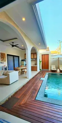 a living room with a swimming pool in a house at Villa Alkasa - Legian 400m to beach in Badung