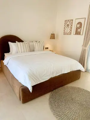 a bedroom with a large bed with white sheets at Villa Alkasa - Legian 400m to beach in Badung