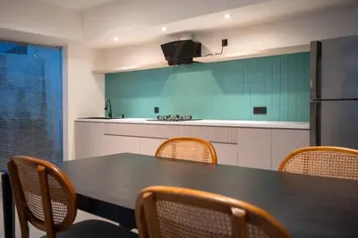 a kitchen with a table and chairs and a refrigerator at Villa Tara in Seminyak