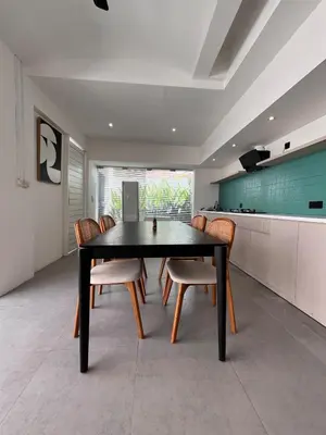 a dining room with a black table and chairs at Villa Tara in Seminyak