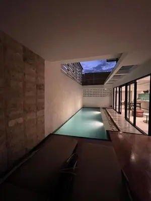 a swimming pool in the middle of a house at Villa Tara in Seminyak
